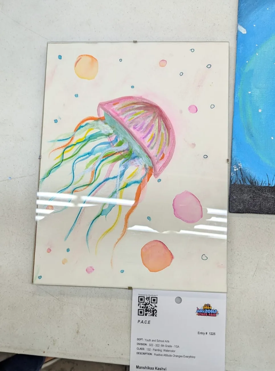 Drifting Currents (State Fair Selection) — This vibrant watercolor captures a translucent jellyfish floating among soft sea bubbles. It explores fluid motion, grace, and light within the deep ocean. I painted and sold this.